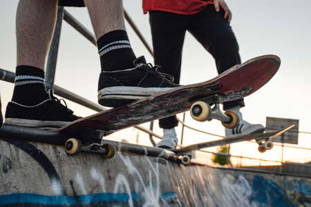 Two skateboarders at skate park in daytime outdoors