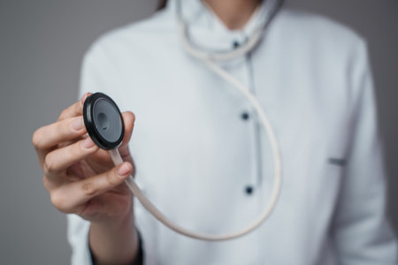 Woman doctor with stethescope dressed in white labcoatの写真素材