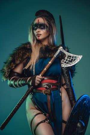 Majestic huntress from past with hatchet and shieldの写真素材