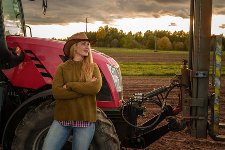Confident farmer woman and modern combain harvesterの写真素材