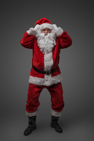 Angry santa claus with red costume staring at cameraの写真素材