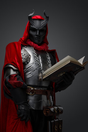 Mystic priest of dark cult with red robe and bookの写真素材