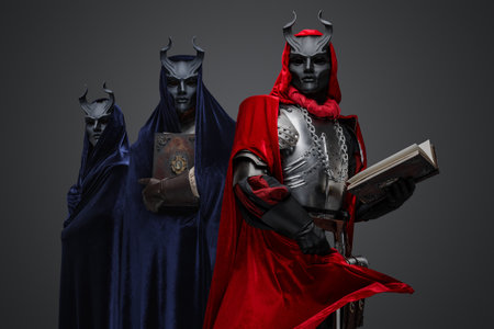 Haunted occultist with book and two members of cultの写真素材