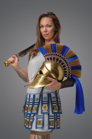 Proud greek warrior woman with golden plumed helmet and sword.の写真素材