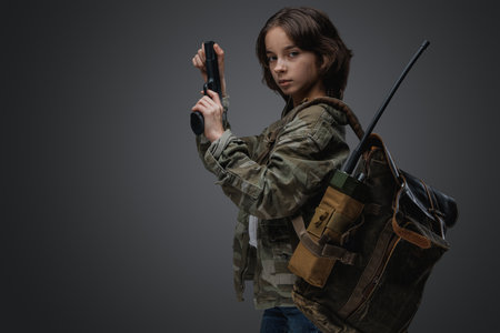 Post apocalyptic girl teenager with backpack and pistolの写真素材