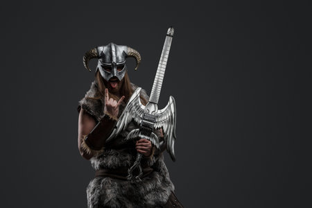 Ancient viking with guitar and horned helmet looking at cameraの写真素材