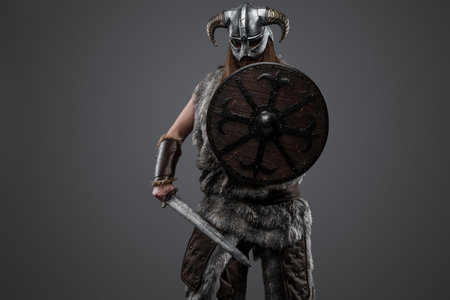 Barbaric viking with shield and sword in fighting stanceの写真素材