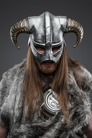 Headshot of savage viking dressed in fur and horned helmetの写真素材