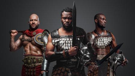 Greek warriors from past posing against grey backgroundの写真素材