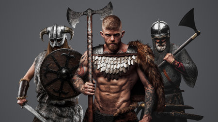 Three viking from past with axes against gray backgroundの写真素材