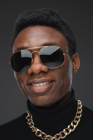 Headshot of smiling black man dressed in stylish clothes