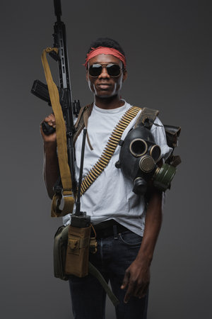 Black somali pirate with sunglasses against grey backgroundの写真素材