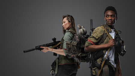 Woman and man survivors with guns in post apocalyptic settingの写真素材