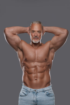 This attractive mature muscular man with a stylish salt and pepper beardの写真素材