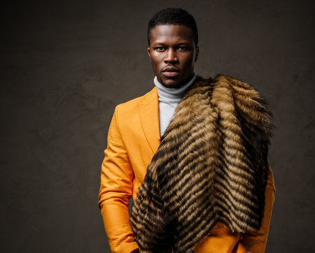 Stylishly dressed dark-skinned man wearing a yellow jacket and wild animal furの写真素材