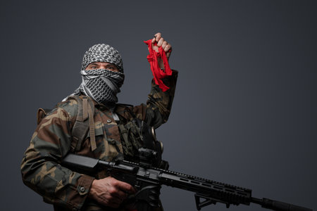middle eastern soldier, camo gear with red clothの写真素材