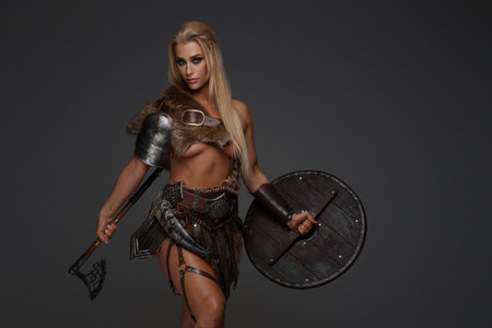 Savage female barbarian, leather armor with axe and shieldの写真素材