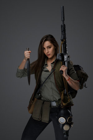 Determined middle eastern survivor, dagger and rifle poseの写真素材