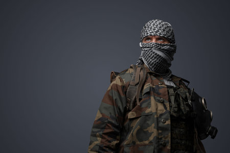 Middle eastern militant, camouflage uniform on gray background