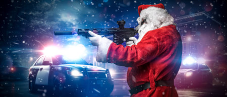 Action Santa: Armed Santa Points Amid Police Lights in Snowy Nightの写真素材