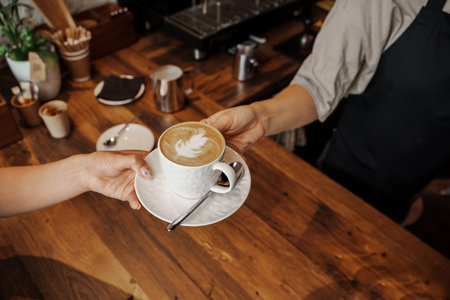 Handoff of a Cappuccino at Coffee Shopの写真素材