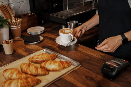 Barista Serving Coffee and Croissants