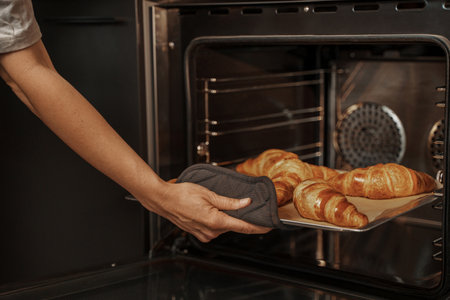 Freshly Baked Croissants Taken Out of Ovenの写真素材