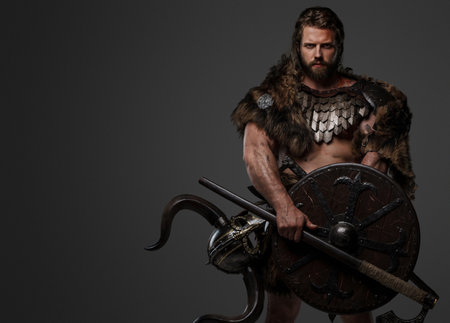 A fearless Viking warrior with a majestic beard adorned in fur and light armorの写真素材
