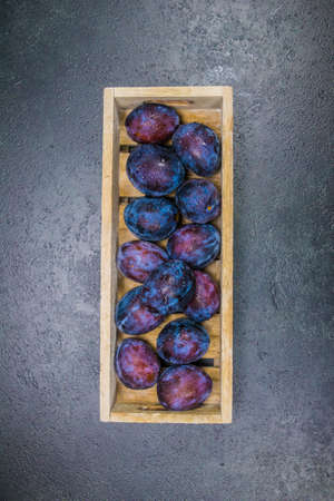 Fresh Plums in a wood boxの写真素材