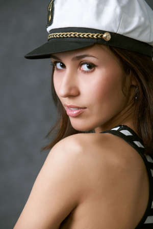 portrait of a woman in a captain hatの写真素材