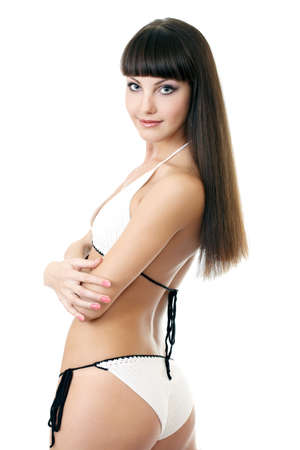 Sexy underwear model posing in a studio in a handmade swimsuit isolated on whiteの写真素材