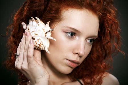 beautiful woman with red curly hairの写真素材