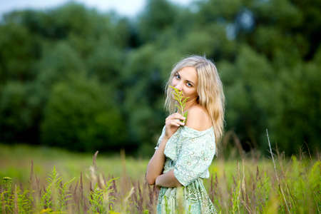 young blond woman outdoors on a summer dayの写真素材