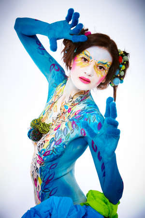 Creative body-art painted on a beautiful young adult womanの写真素材