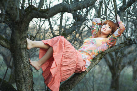 portrait of attractive beautiful red-haired woman in a park outdoorsの写真素材