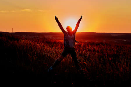 Healthy woman celebrating during a beautiful sunset. Happy and Free.