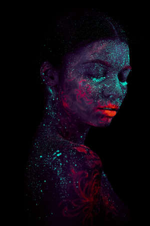 Profile portrait of a beautiful girl alien. Ultraviolet body art blue night sky jellyfishの写真素材