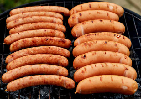 Closeup BBQ with fiery sausages on the grillの写真素材
