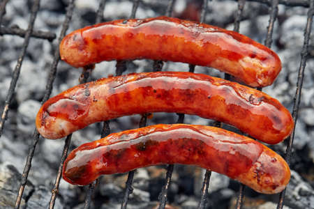 Closeup BBQ with fiery sausages on the grillの写真素材