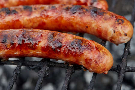 Closeup BBQ with fiery sausages on the grillの写真素材