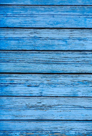 A fence of dark blue and gray turquoise boards. Blank background with a texture of wooden slatsの写真素材