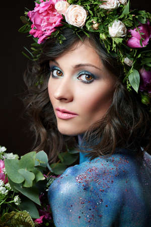 Close up beauty portrait of a young woman with peony.の写真素材