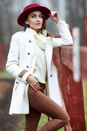 Lovely lady woman in a red hat outdoorsの写真素材