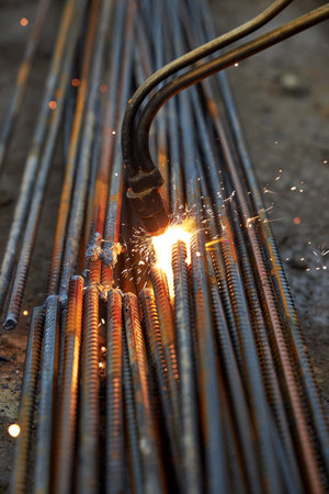 A person works with welding, sparks, close up, construction