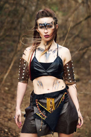 Beautiful amazon woman posing outdoors late fallの写真素材