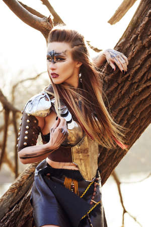 Beautiful amazon woman posing outdoors late fallの写真素材