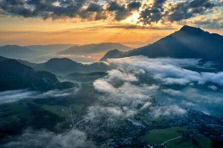 areal shot landscape from above in sunrise. lake mountains cloudsの写真素材