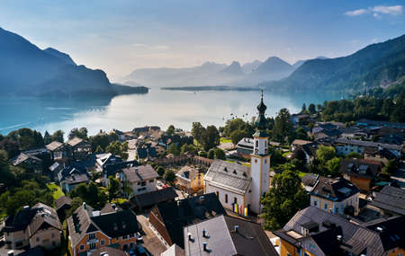 Hallstatt, Austria. View to Hallstattersee Lake and Alps mountains summits. Ancient houses at lake...