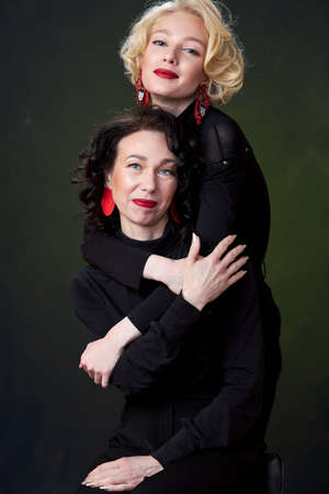 Portrait of beautiful mother daughter possing in a studio. beautiful women of different ages, mothers day, familyの写真素材