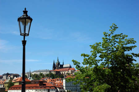 Prague castle and a lantern. Castle is in the middle of lantern and a treeの写真素材